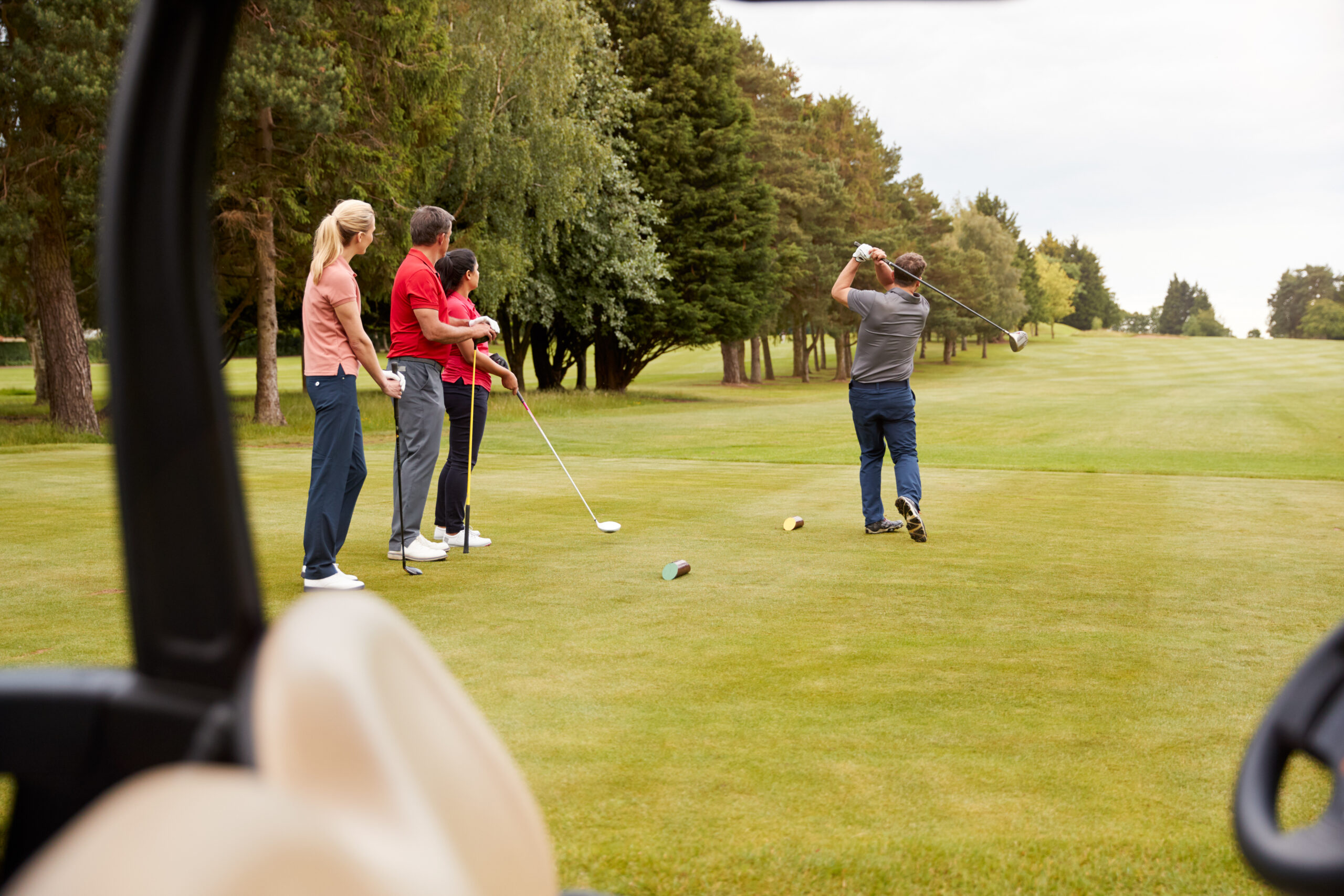 two couples golfing on a course in dunnellon